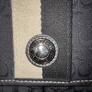 Coach Voyager Messenger Bag with a black signature canvas and leather trim